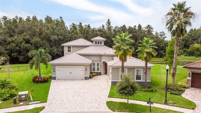 mediterranean / spanish house with a front lawn and a garage