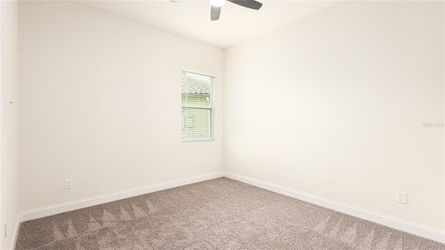 carpeted empty room featuring ceiling fan