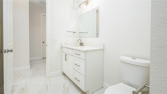 bathroom with vanity, tile patterned flooring, and toilet