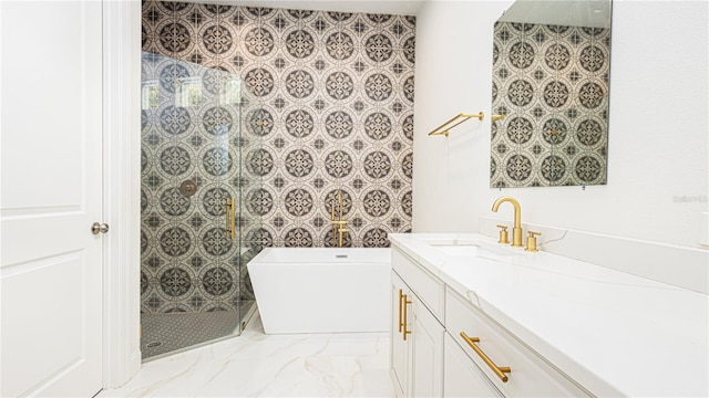 bathroom with a tile shower, vanity, and tile patterned flooring