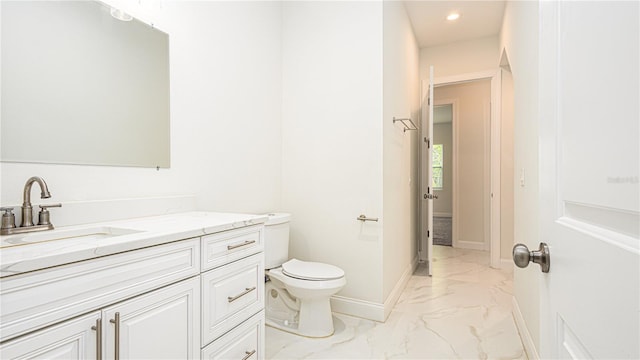 bathroom featuring tile patterned floors, vanity, and toilet