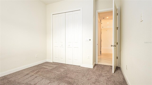 unfurnished bedroom with a closet and carpet