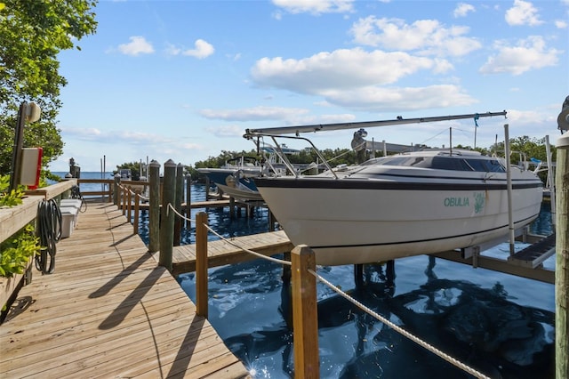 dock area with a water view and boat lift