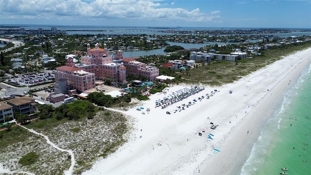 drone / aerial view featuring a beach view and a water view