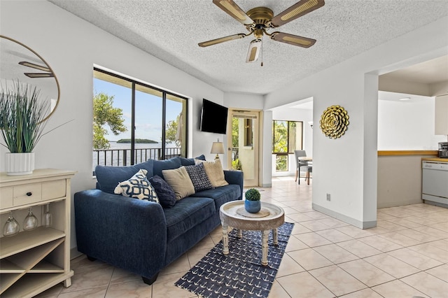 tiled living room with a textured ceiling and ceiling fan