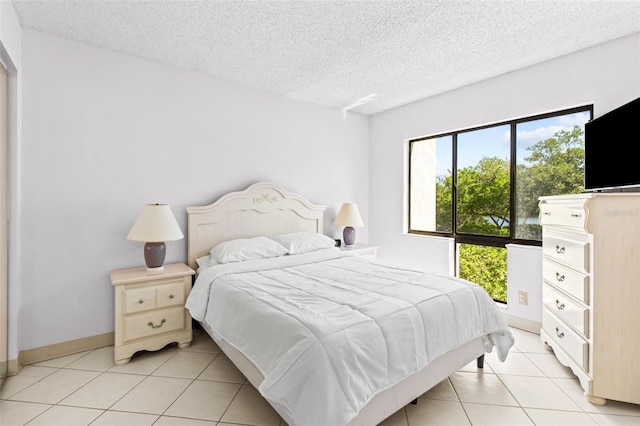 tiled bedroom featuring a textured ceiling