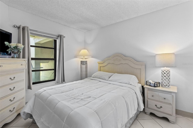 tiled bedroom with multiple windows and a textured ceiling