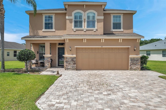116 Caladium Ct, Bradenton, FL 34212 - view of front of house featuring stucco siding, an attached garage, a porch, decorative driveway, and a front lawn