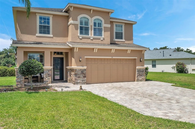 116 Caladium Ct, Bradenton, FL 34212 - view of front of home featuring stucco siding, decorative driveway, a front yard, and a garage