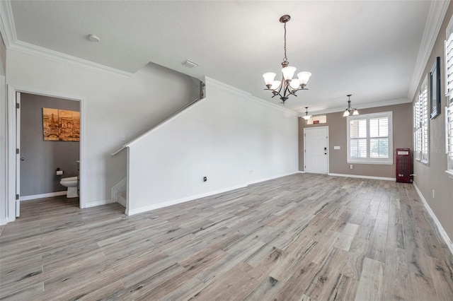 unfurnished living room with ornamental molding, a chandelier, and light hardwood / wood-style flooring