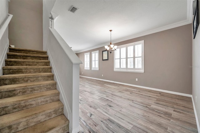 116 Caladium Ct, Bradenton, FL 34212 - staircase featuring baseboards, ornamental molding, wood finished floors, and a chandelier