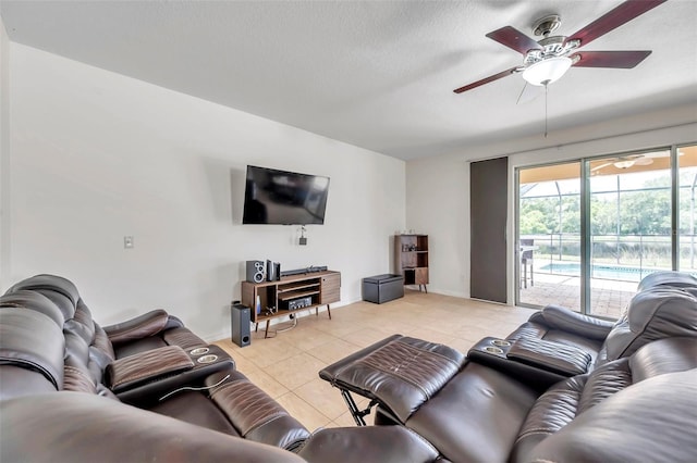 tiled living room with a textured ceiling and ceiling fan