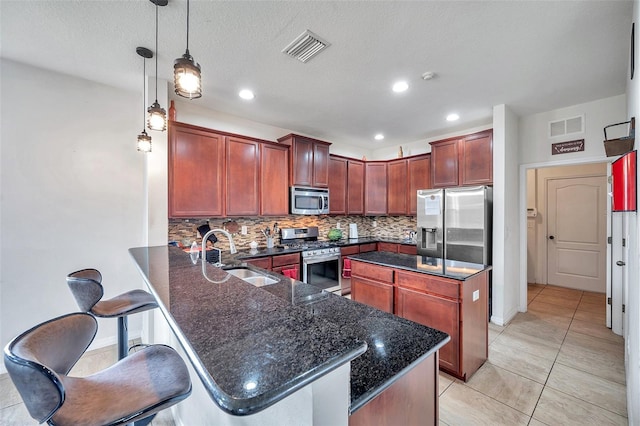 116 Caladium Ct, Bradenton, FL 34212 - kitchen featuring stainless steel appliances, a sink, tasteful backsplash, a peninsula, and light tile patterned floors