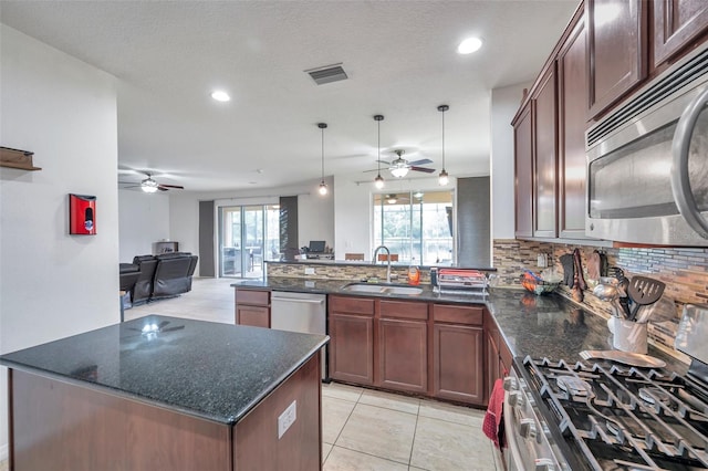 kitchen with pendant lighting, sink, backsplash, appliances with stainless steel finishes, and ceiling fan