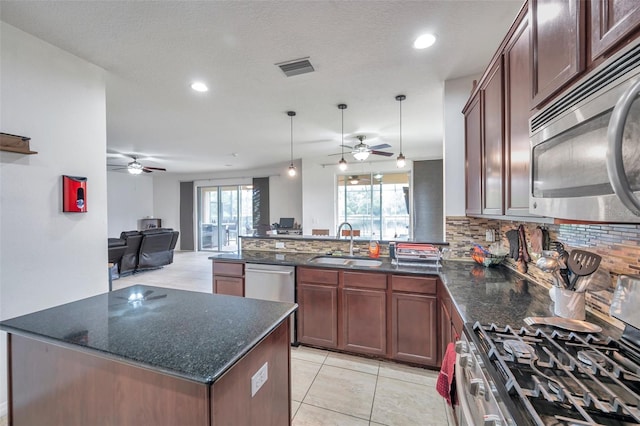 116 Caladium Ct, Bradenton, FL 34212 - kitchen with appliances with stainless steel finishes, a ceiling fan, a sink, a peninsula, and recessed lighting