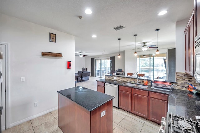 kitchen with a kitchen island, sink, ceiling fan, and stainless steel appliances