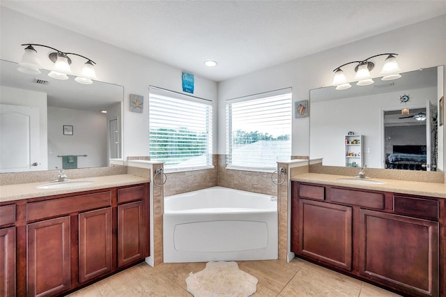 bathroom featuring vanity, a bathtub, and tile patterned floors