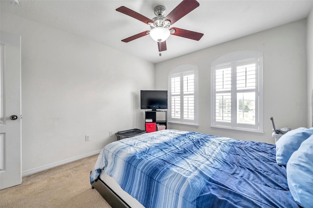 bedroom with ceiling fan and light colored carpet