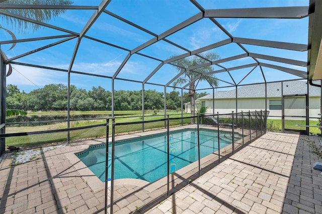 116 Caladium Ct, Bradenton, FL 34212 - outdoor pool featuring a patio area, view of wooded area, and glass enclosure