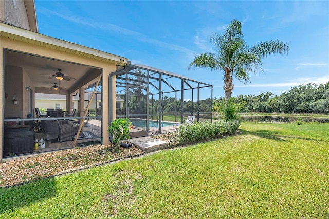 116 Caladium Ct, Bradenton, FL 34212 - view of grassy yard with ceiling fan, a patio area, an outdoor pool, a water view, and a lanai