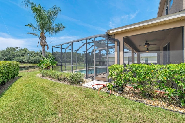 view of yard featuring ceiling fan and a lanai