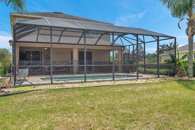 rear view of house with a lawn, a fenced in pool, a lanai, and a patio area