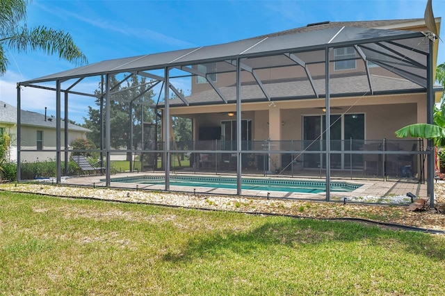 116 Caladium Ct, Bradenton, FL 34212 - back of house with an outdoor pool, stucco siding, and a yard
