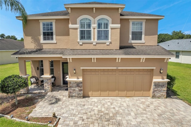 116 Caladium Ct, Bradenton, FL 34212 - view of front of property featuring stucco siding, an attached garage, covered porch, driveway, and a front lawn