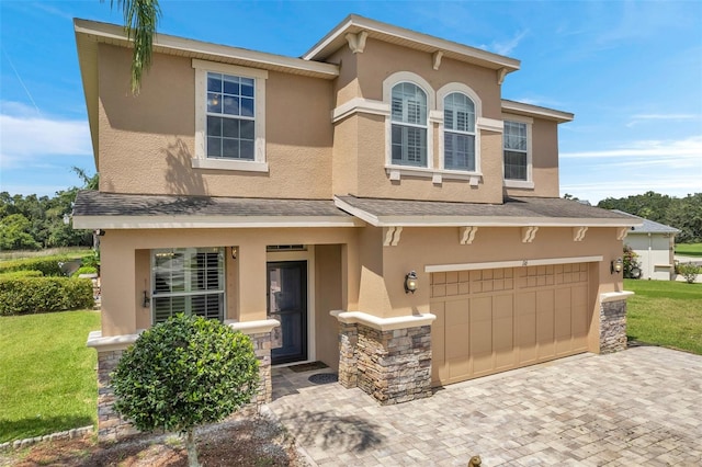 view of front of house featuring a garage and a front lawn