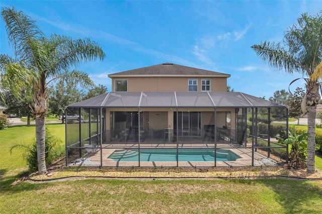 view of swimming pool featuring a patio, glass enclosure, and a yard