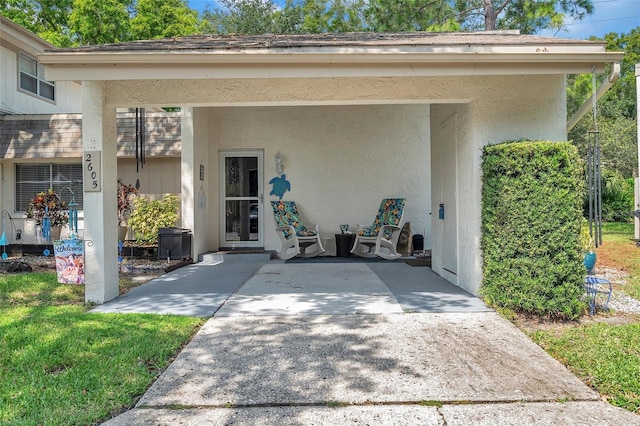 doorway to property with a patio and a yard