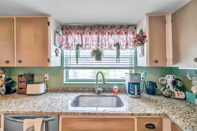 kitchen featuring sink, light stone counters, and dishwasher