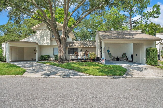 view of front facade with a carport and a front yard