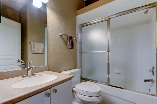 full bathroom with vanity, toilet, and enclosed tub / shower combo