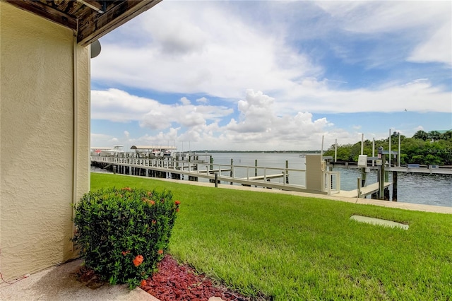 view of dock featuring a water view and a lawn