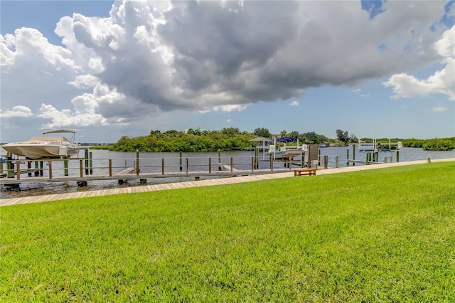 dock area with a water view and a yard