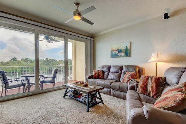 carpeted living room featuring ornamental molding, a textured ceiling, and ceiling fan