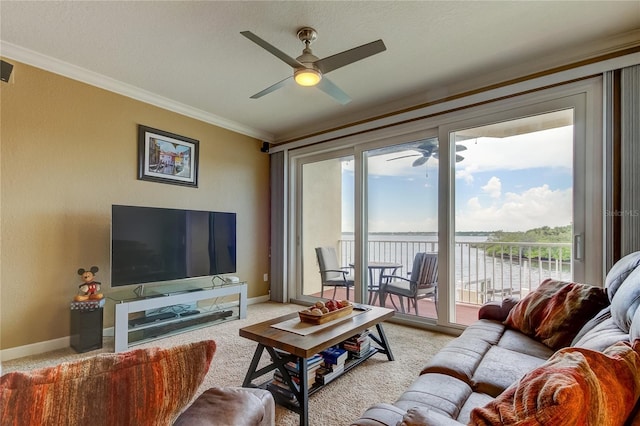 carpeted living room with crown molding and ceiling fan