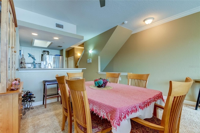 dining space featuring crown molding, light colored carpet, and a textured ceiling