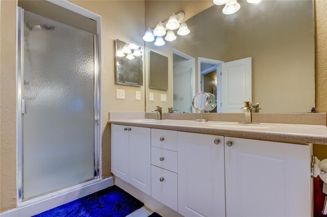 bathroom with walk in shower and vanity