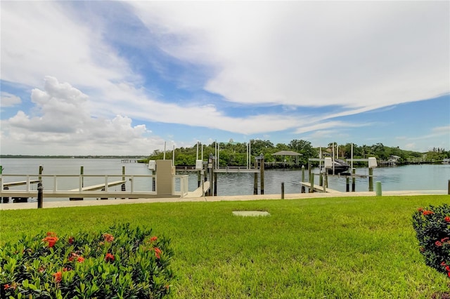 view of dock featuring a water view and a yard