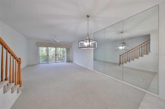 unfurnished room featuring light carpet and ceiling fan with notable chandelier