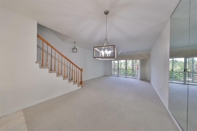 unfurnished living room featuring light carpet and a notable chandelier