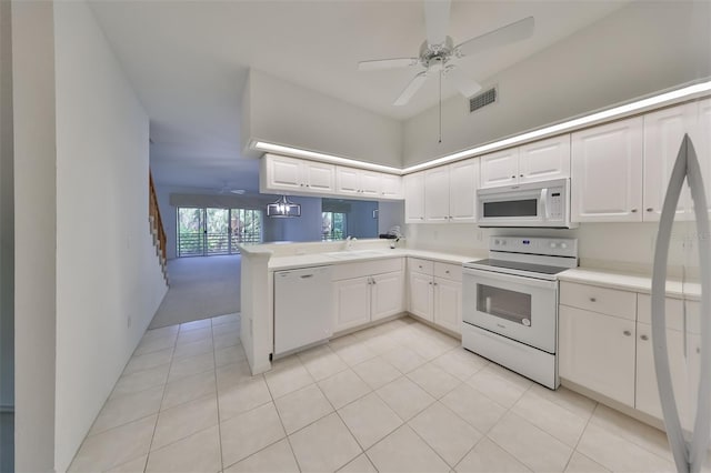 kitchen with sink, white appliances, ceiling fan, white cabinets, and kitchen peninsula