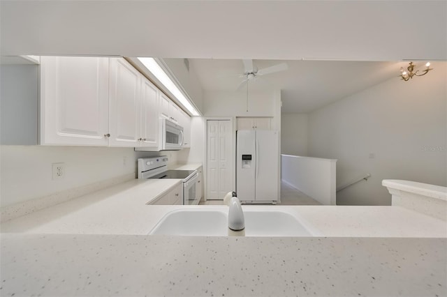 kitchen with white appliances, light stone countertops, white cabinetry, ceiling fan, and sink