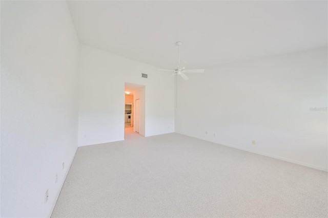 spare room featuring light colored carpet and ceiling fan