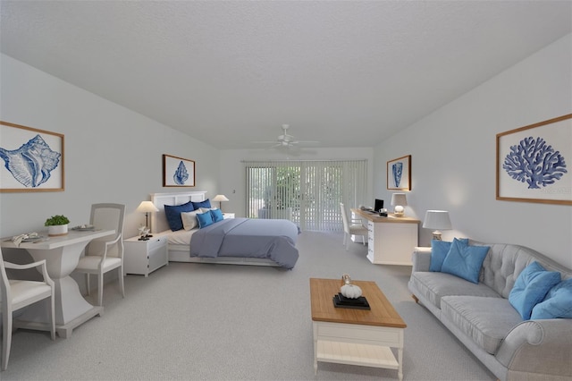 carpeted bedroom with ceiling fan, a textured ceiling, and access to outside