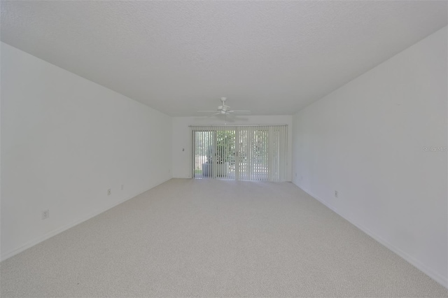 unfurnished room featuring ceiling fan, carpet flooring, and a textured ceiling