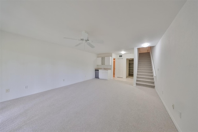 interior space with ceiling fan and light carpet