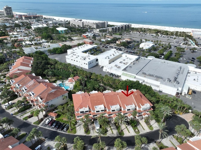 birds eye view of property with a water view and a beach view